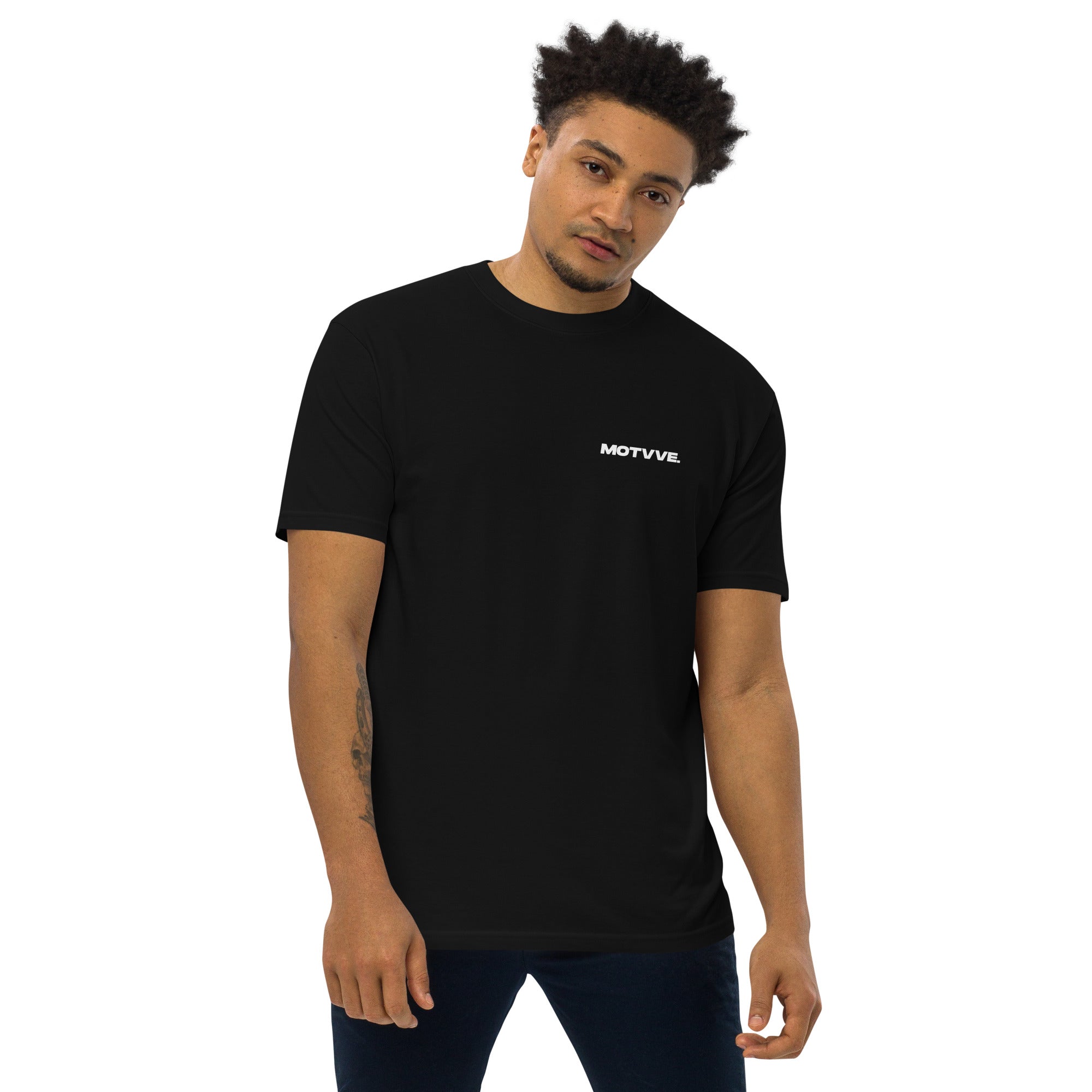 Man wearing a black t-shirt with 'MOTVVE' logo on a white background