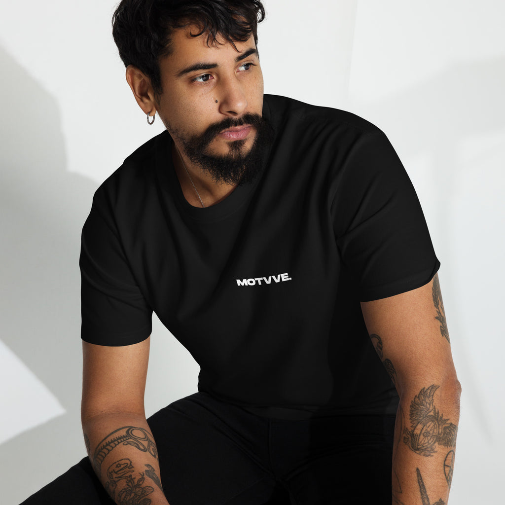 Man wearing a black t-shirt with 'MOTVVE' logo on a white background