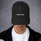 Model wearing MOTVVE black mesh trucker hat